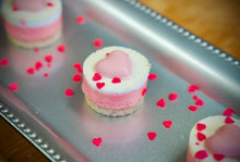 Load image into Gallery viewer, Mini Mini 2-inch Strawberry Cheesecakes topped with Hand-made White Chocolate Hearts
